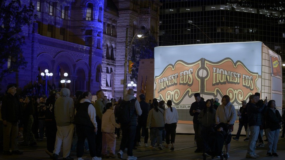 Honest Ed's sign installation with a crowd at Nuit Blanche